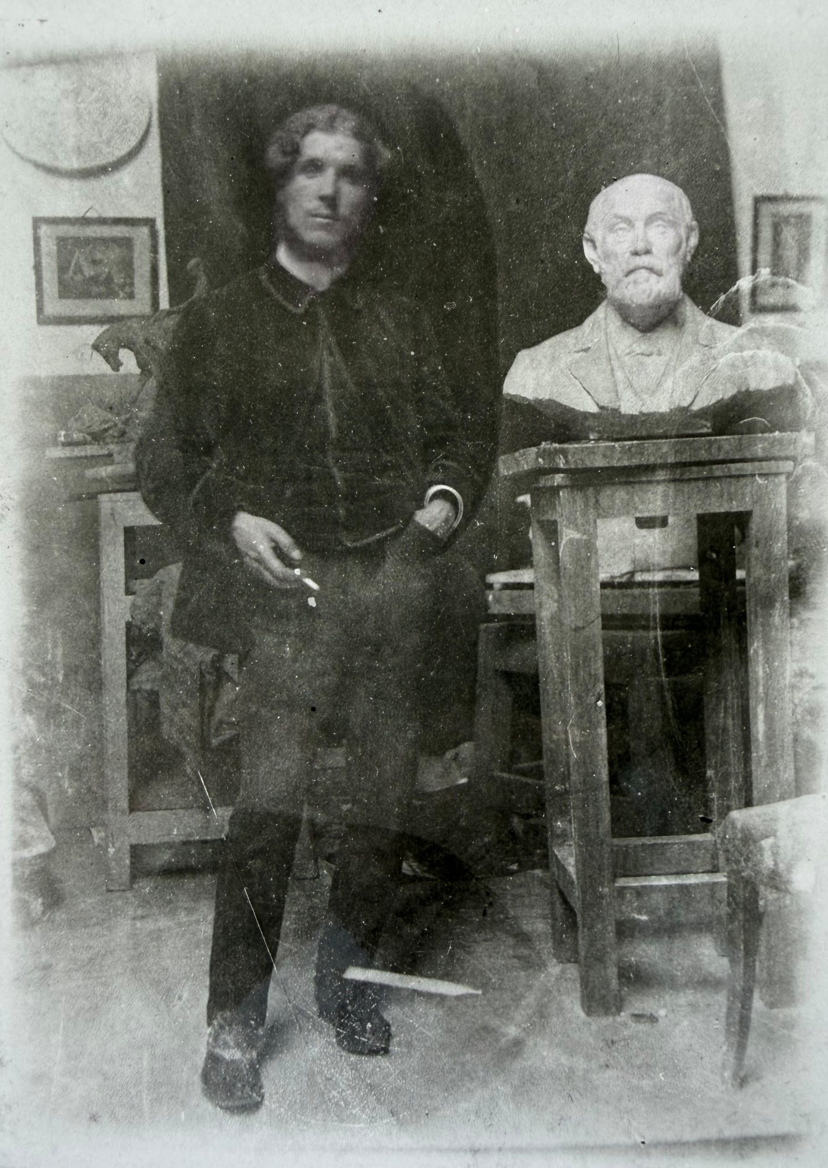 Rik Wouters seated in his studio beside a plaster bust