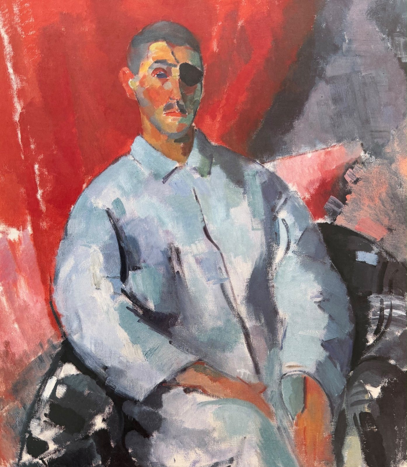 Self-portrait of the artist seated in a pale shirt, wearing a black eye-patch, against a red background